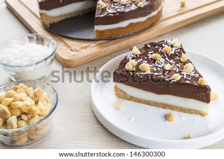 A decadent haupia and chocolate custard pie topped with shaved coconut, macadamia nuts and shaved chocolate