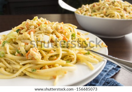 Pasta salad with lump crab, hard-boiled eggs, carrots, onions, celery, green onions, parsley and a delicious creamy dressing