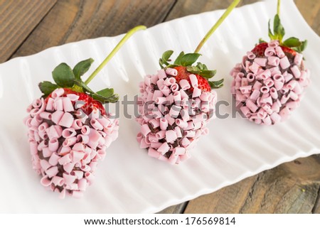 Strawberries dipped in chocolate and covered with pink chocolate curls
