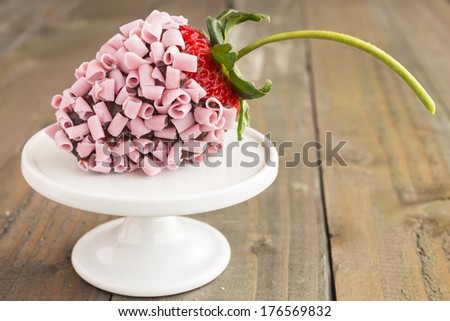 Strawberry dipped in chocolate and covered with pink chocolate curls