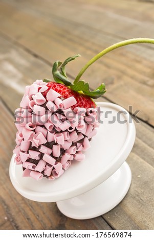 Strawberry dipped in chocolate and covered with pink chocolate curls