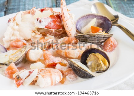 Seafood stew made with lobster, crab, shrimp and clams cooked in coconut milk with tomatoes and onions