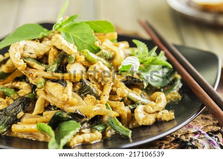 Chicken stir-fried with onion, garlic, curry paste, long bean, bamboo shoots, and coconut milk, served with Thai basil