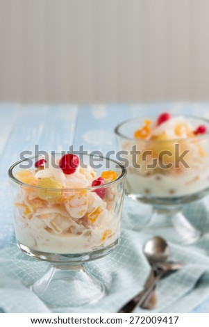 Fruit cocktail with coconut cubes and shaved coconut, mixed with cream cheese