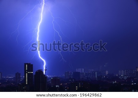 Blue Thunderbolt. Intense flash of lightning hitting a construction crane.