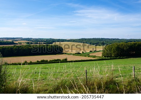 English Countryside. Typical view of the English landscape on a summers evening. Mixed land use woods and farming.