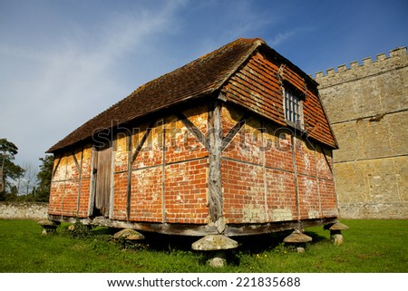 Staddle stone barn. Grain store on large mushroom shaped stones. Vintage barn using stone blocks to keep the structure clear of the ground.