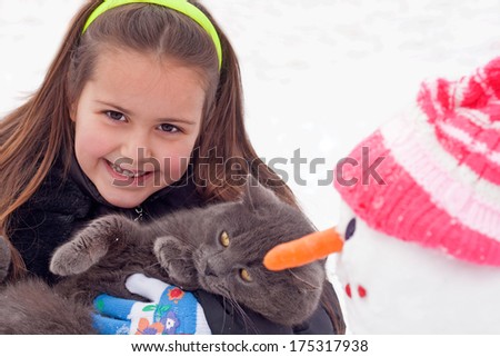 cute girl with cat winter portrait
