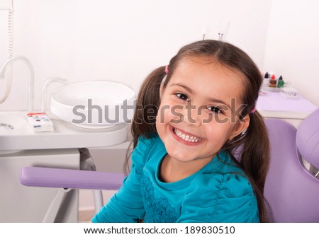 cute little girl in the dentist chair smiling