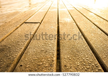 Wet wooden background with warm light