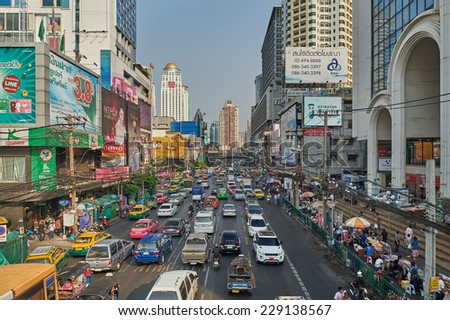 Bangkok, Thailand - February 26, 2014: Traffic moves slowly along a busy road on May 2, 2014 in Bangkok, Thailand. Annually an estimated 150,000 new cars join the already heavily congested streets.