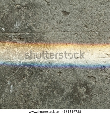 Rainbow lighting on dirty concrete ground