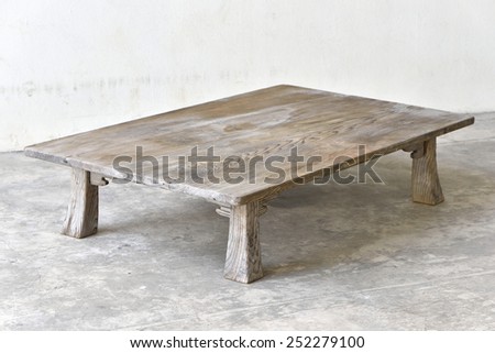Antique wooden table on the ground