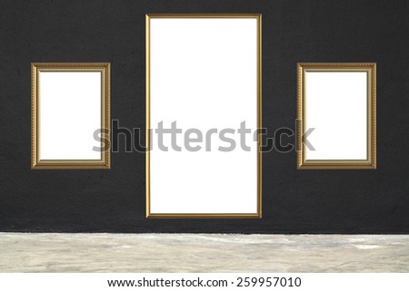 Antique gold wood frame on black concrete wall in concrete room