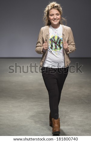 NEW YORK - MARCH 08 2014: A model is walking the runway at CCandy Clothing 2014 Fall Collection Show during petitePARADE Kids Fashion Week