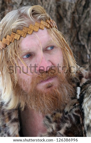 close-up portrait of a man with a red beard and mustache, blond hair, wearing a fur clothing, bandage on his head, <ochelye>, looking to the side