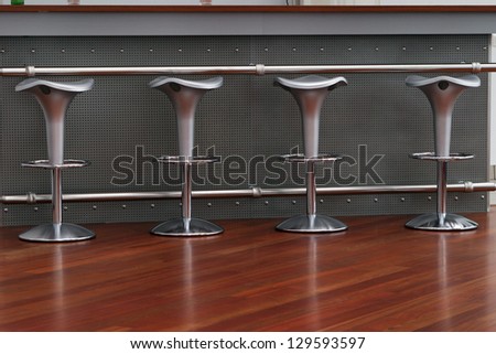 series of gray bar stools at the bar
