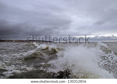 Handsome, tall, raging waves in cloudy weather