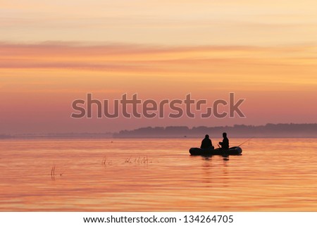 fishermen go fishing from a boat at sunrise