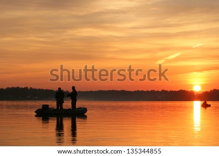 fishermen go fishing from a boat at sunrise
