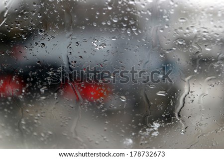 drops of condensation on the windshield of a car stuck in traffic jams on the road