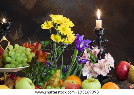 close-up elegant still life of various ripe fruits and delicate flowers on a dark background studio