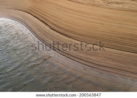 macro isolated texture of river sand at low tide the water\'s edge