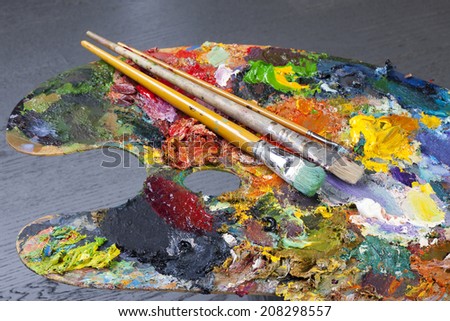 macro artist\'s palette, texture mixed oil paints in different colors and saturation studio