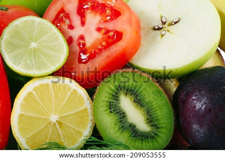close-up of assorted cut ripe fruits and vegetables studio