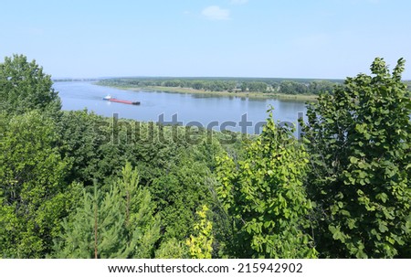 summer landscape barge on the river with a tree-lined beaches on a sunny day, the view from the top