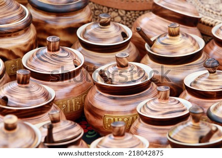 close-up a few pots with lids made of wood brown on the market