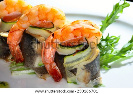 macro a second dish of fish and shrimp with creamy sauce, herbs and vegetables on a white plate on a black background studio
