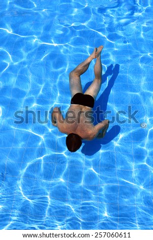 isolated azure water pool and swimmer in the water
