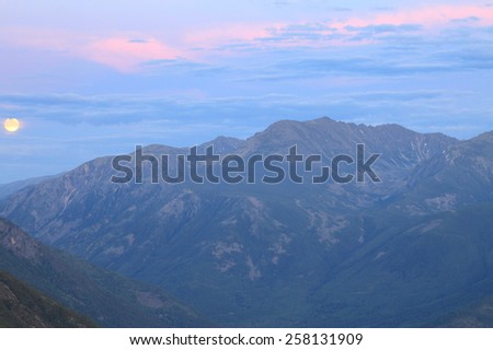 picturesque landscape moonrise in the Baikal Mountains during the night summer night