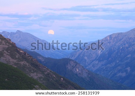 picturesque landscape moonrise in the Baikal Mountains during the night summer night