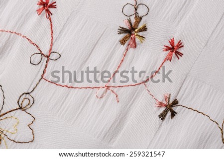 macro texture of white fabric with floral embroidery studio