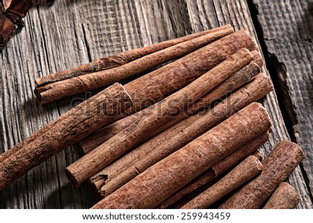 close-up isolated cinnamon sticks on a background of the old board studio