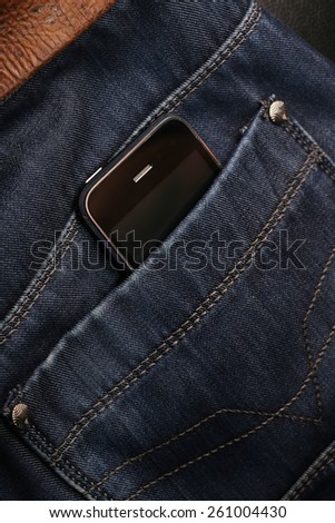 close-up of a mobile phone in your pocket men\'s trousers