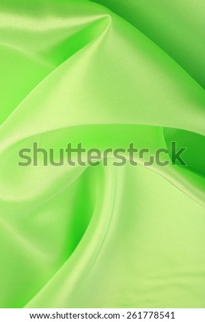 macro texture smooth satin fabric light green color studio