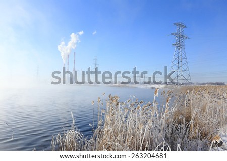 winter landscape Hydroelectric in dense fog early in the morning at sunrise
