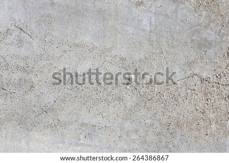 macro texture fragment of the concrete slab with cracks in the sunlight in the winter
