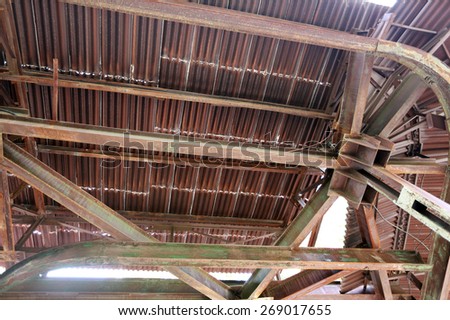 close-up of old rusty metalwork, leaky roof and the rack from the bottom up view
