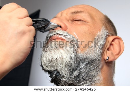 close-up portrait of an adult male color beard and mustache on white background studio