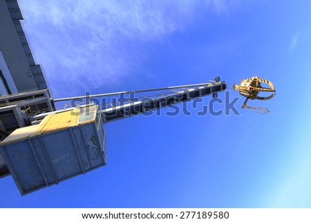 industrial landscape close-up gantry crane isolated on a blue sky background