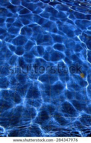 isolation turquoise water outdoor swimming pool with reflections of sunlight