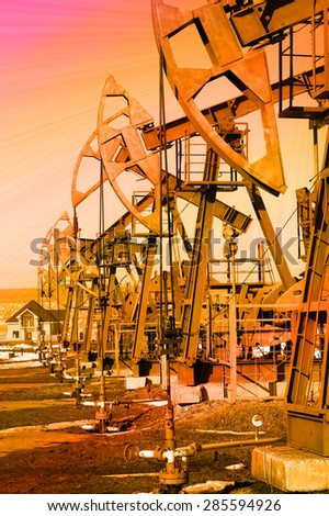 industrial landscape oil pumps in the early spring on a sky background instagram filter