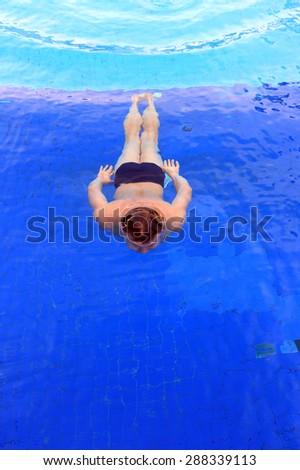 isolation swimmer underwater in clean clear pool