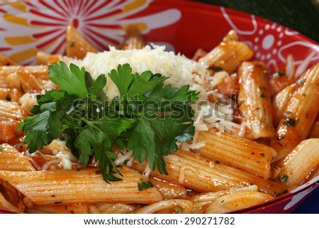 macro appetizing Feathers Pasta with cheese and sauce on dark background studio