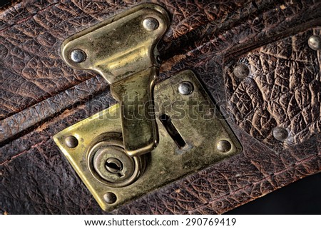 close-up fragment of locks and fasteners on the vintage leather suitcase brown