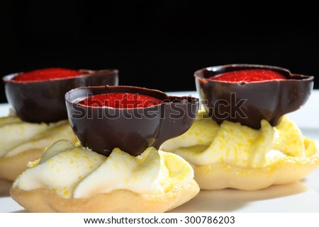 close-up exquisite dessert in the form of chocolate cups on a dark background Studio